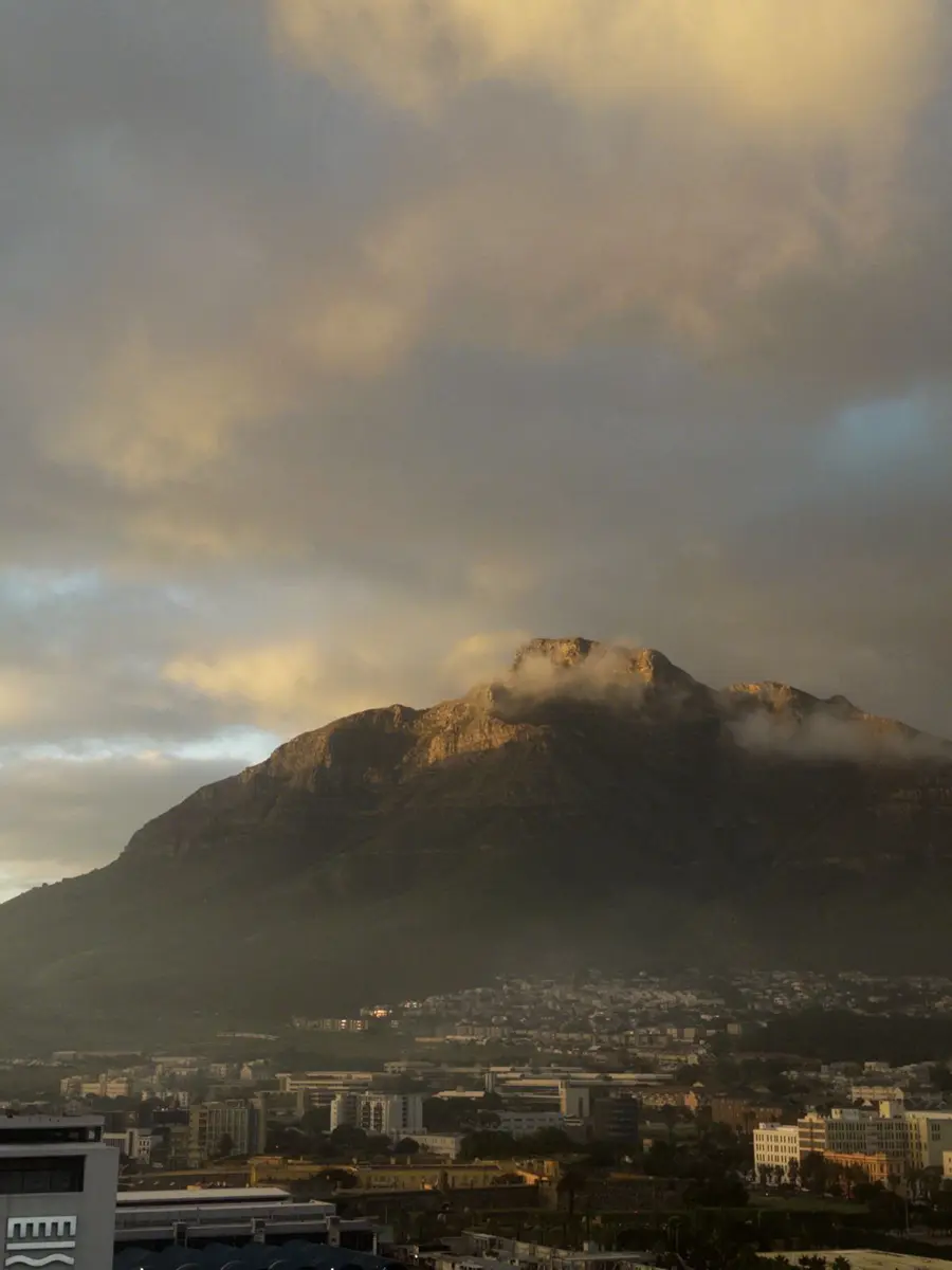 Cloud spilling over a mountain above a city